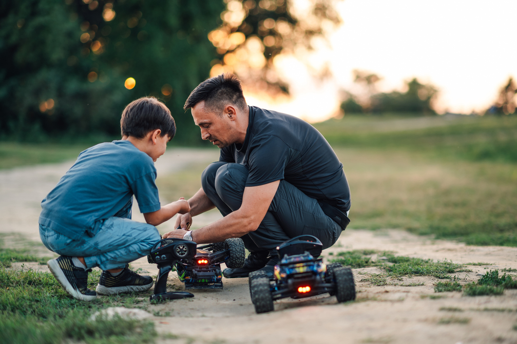 Father with son playing with toy cars