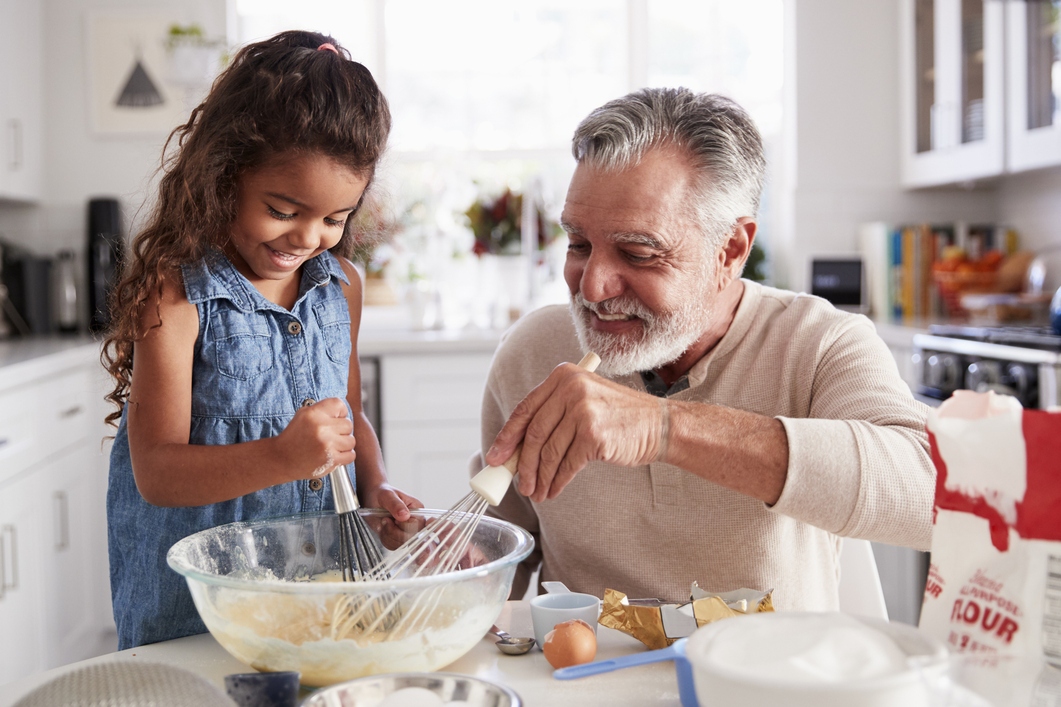 Grandfather cooking with child