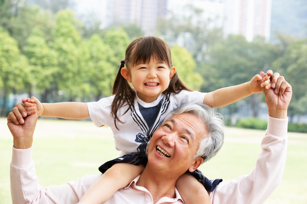Grandfather with granddaughter on shoulders