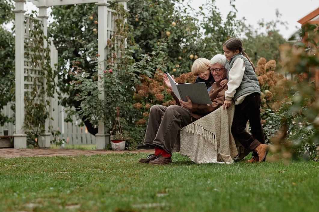 Grandpa reading with grandchildren