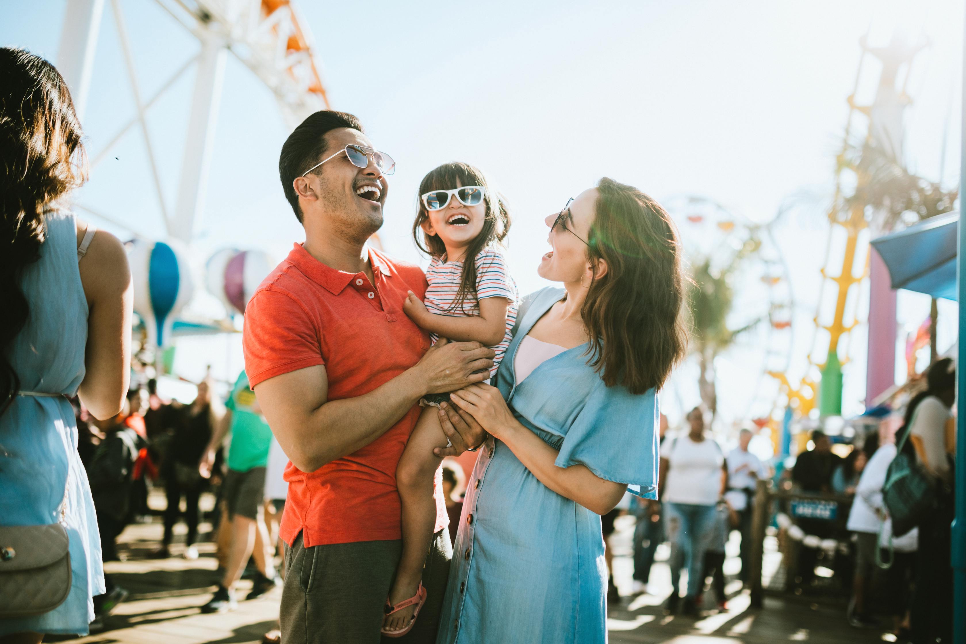 Happy family enjoying a day at the amusement park together