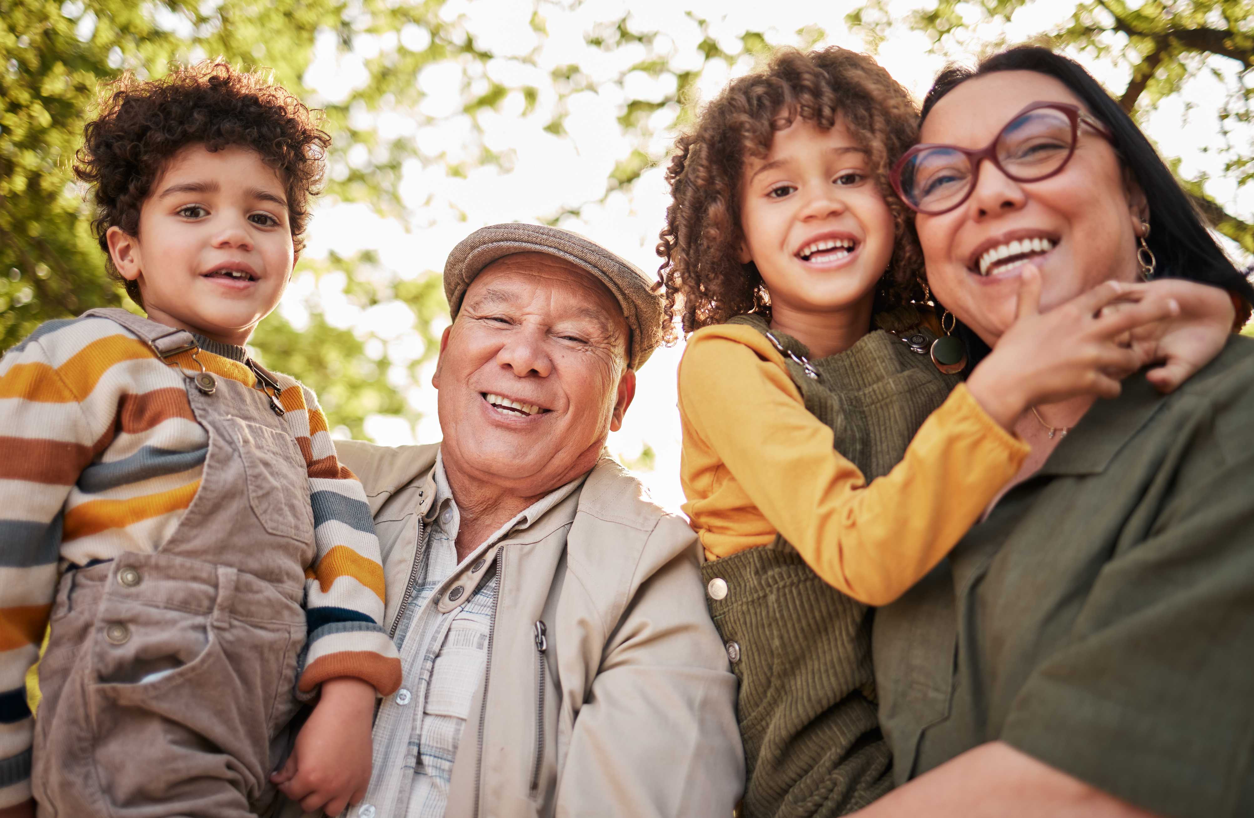 Happy multigenerational family smiling together outdoors in autumn