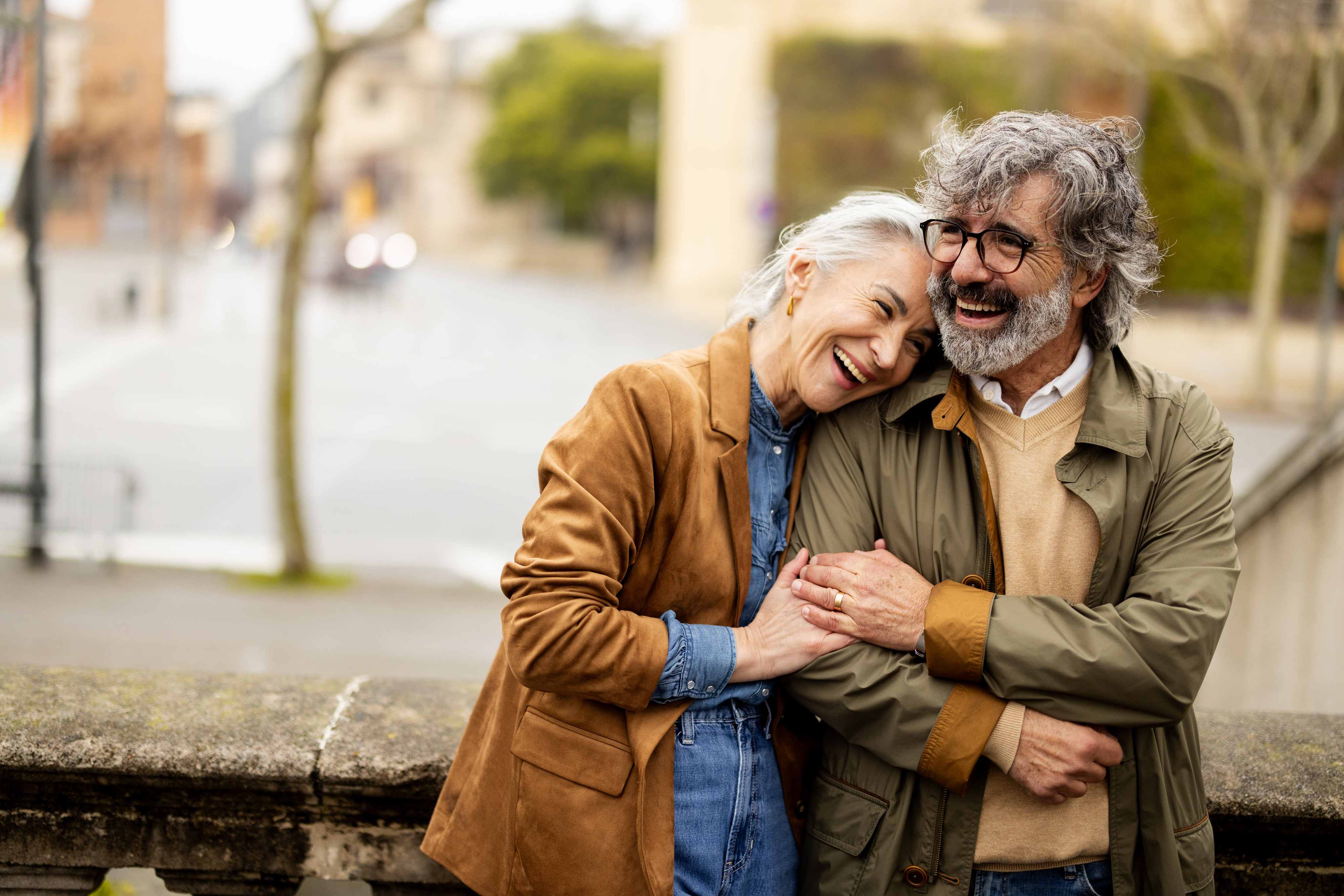 Happy senior couple embracing outdoors on city street