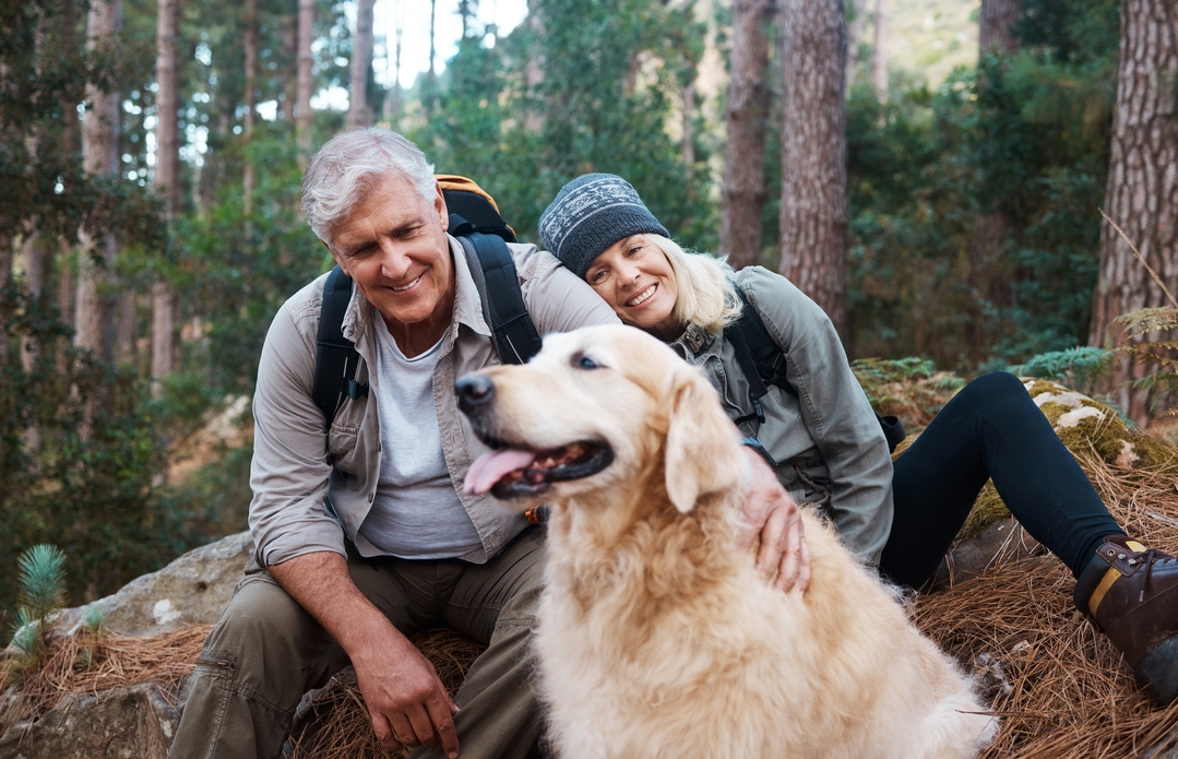 Senior couple hiking with dog
