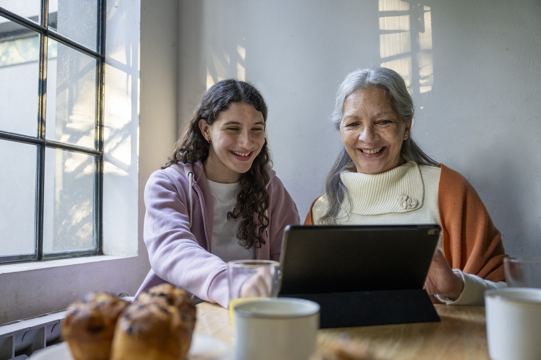Young girl helping grandmother online